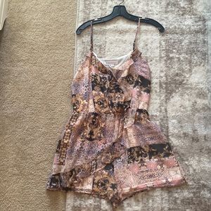 BCBG romper with button snap closure at bust. Band new with tags.